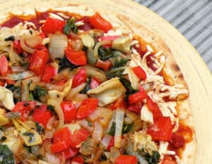 vegan veggie pizza with peppers, onions, and artichokes