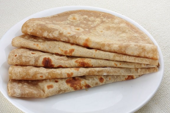 Homemade Chapatis being served on a white plate