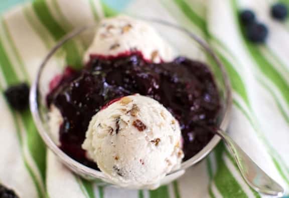 blueberry sauce being served over ice cream
