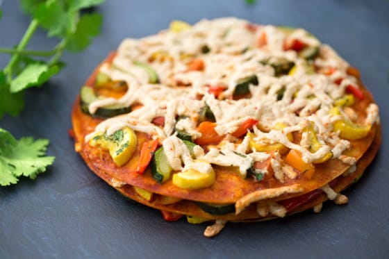 Stacked vegan squash and bell pepper enchiladas