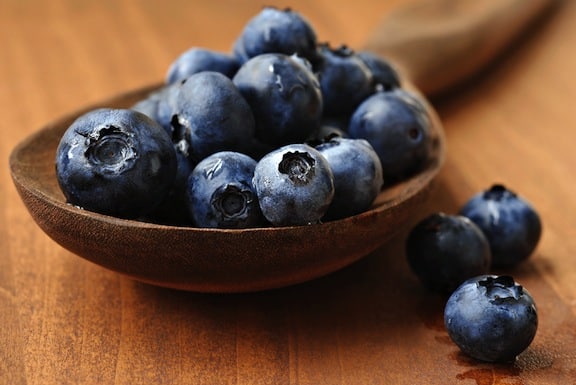 Blueberries on wooden spoon