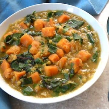 Red lentil soup with sweet potatoes and greens