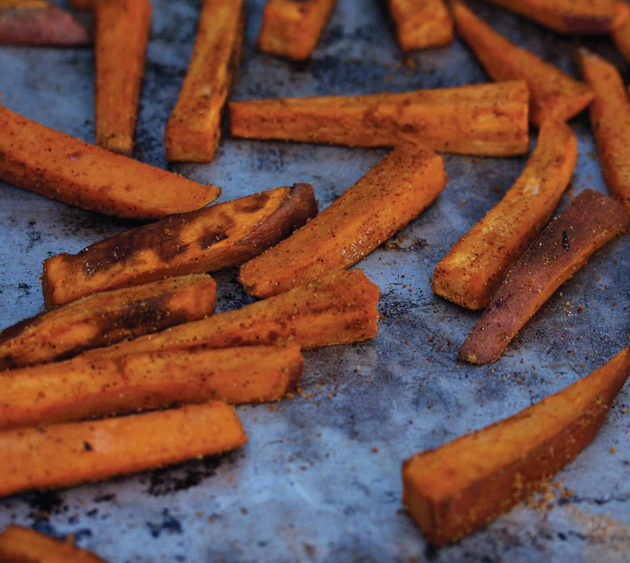 BBQ baked sweet potato fries on a blue gray background