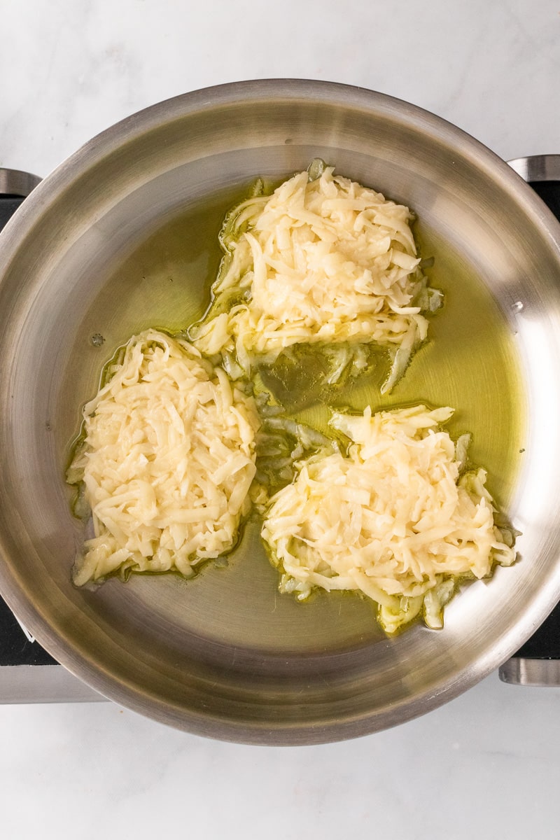 vegan potato pancakes frying in a pan