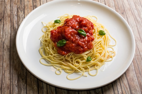 Homemade marinara sauce with fresh tomatoes over spaghetti