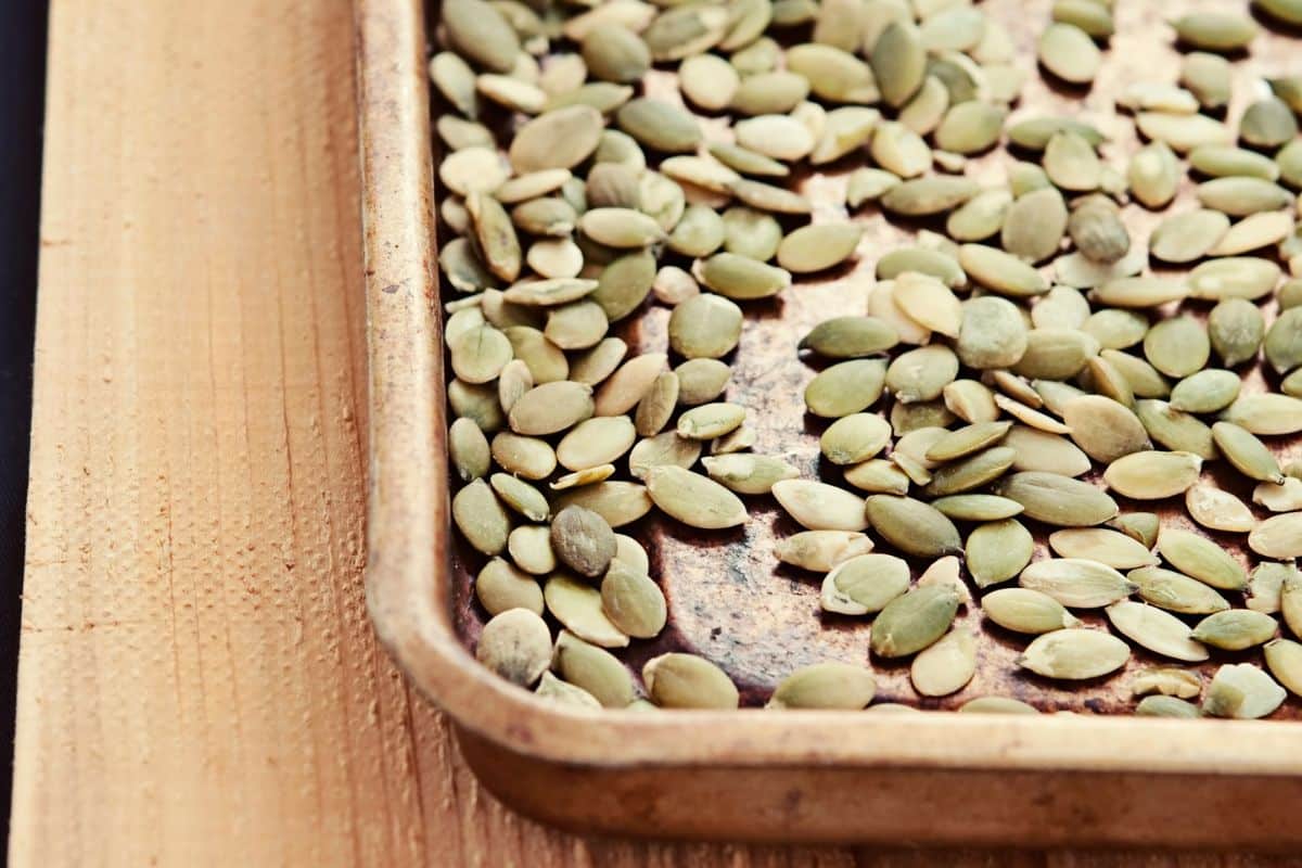 roasting pumpkin seeds on a pan