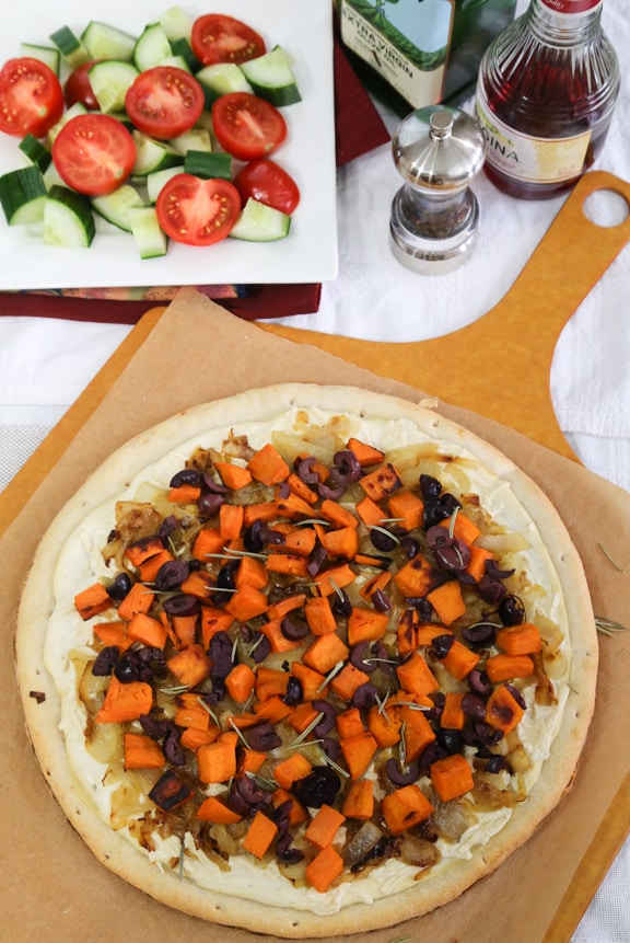 White vegan pizza with sweet potato, onions, and olives