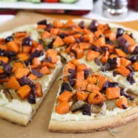 White vegan pizza with sweet potato, onions, and olives