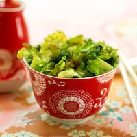 stir fried lettuce in a red bowl