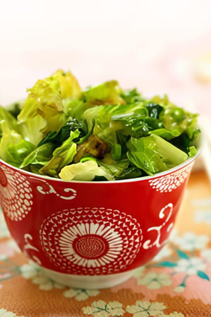 stir fried lettuce in a red bowl