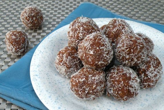 Vegan no-bake coconut maca-roons piled on a plate
