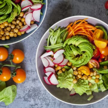 Buddha bowl of mixed vegetable with avocado, carrots, spinach, romsnesco cauliflower and radishes