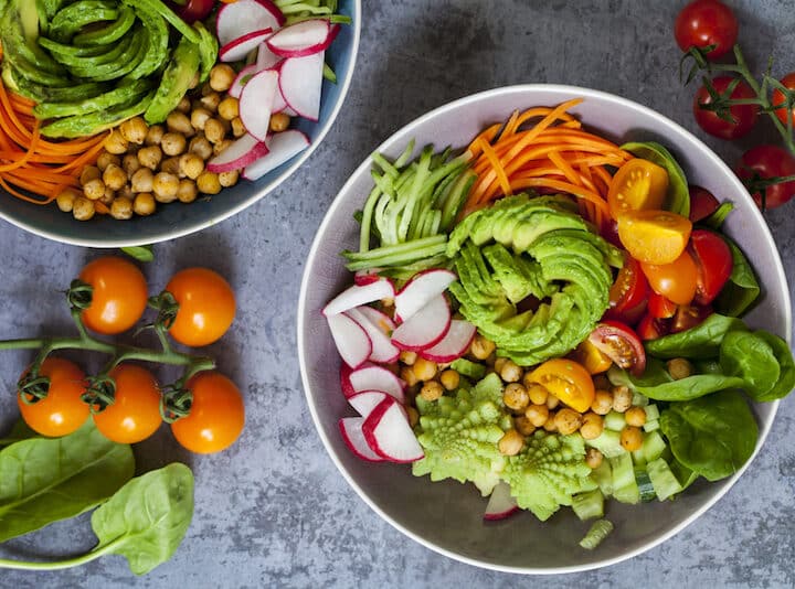 Buddha bowl of mixed vegetable with avocado, carrots, spinach, romsnesco cauliflower and radishes