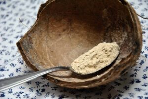 bowl with maca powder on spoon