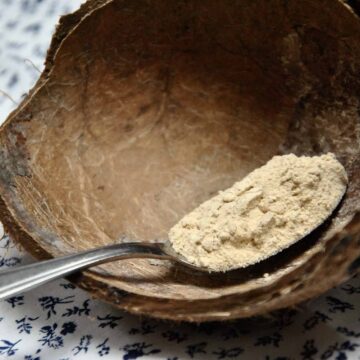 bowl with maca powder on spoon