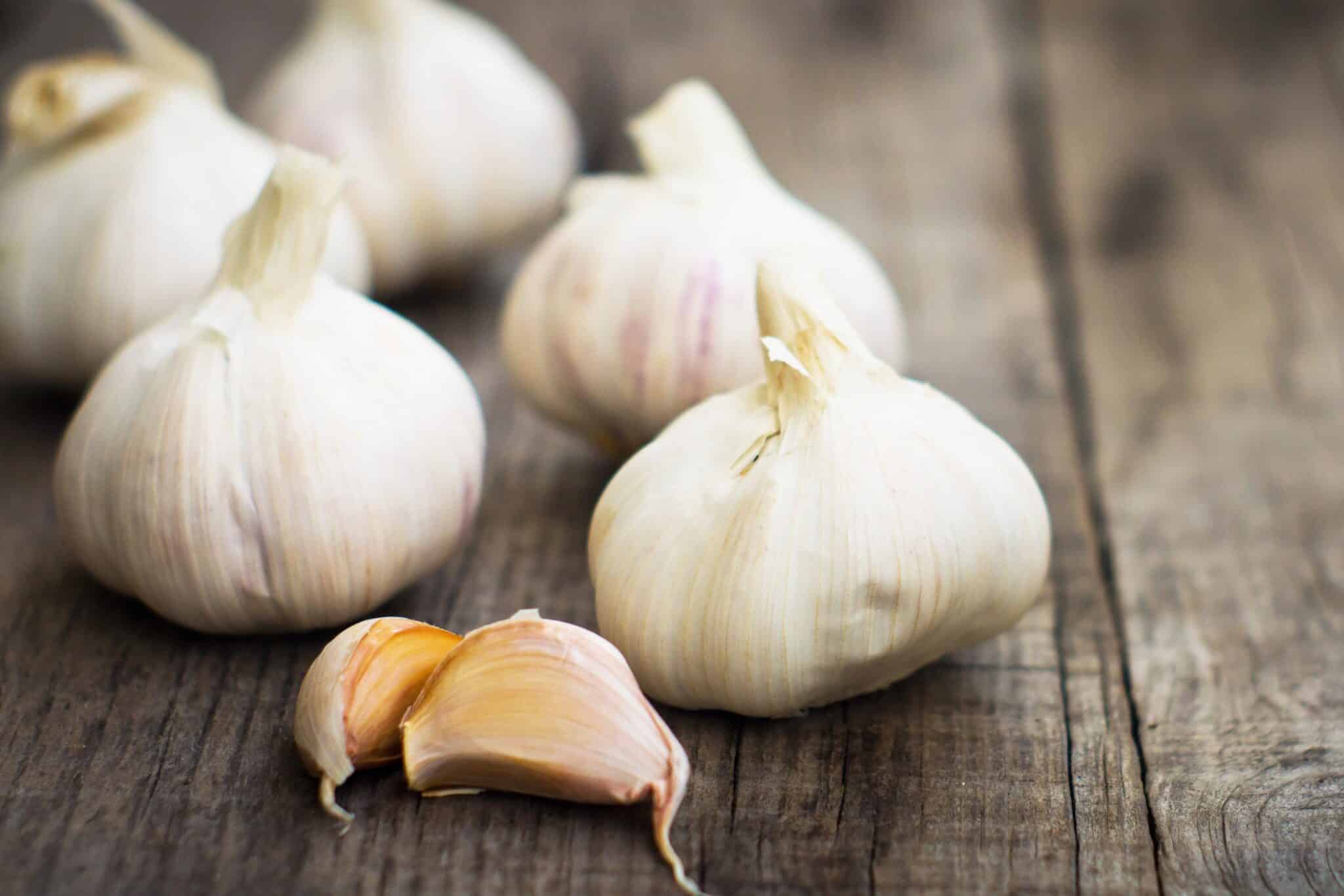 garlic bulbs on a cutting board