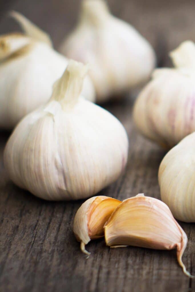 garlic bulbs on a cutting board