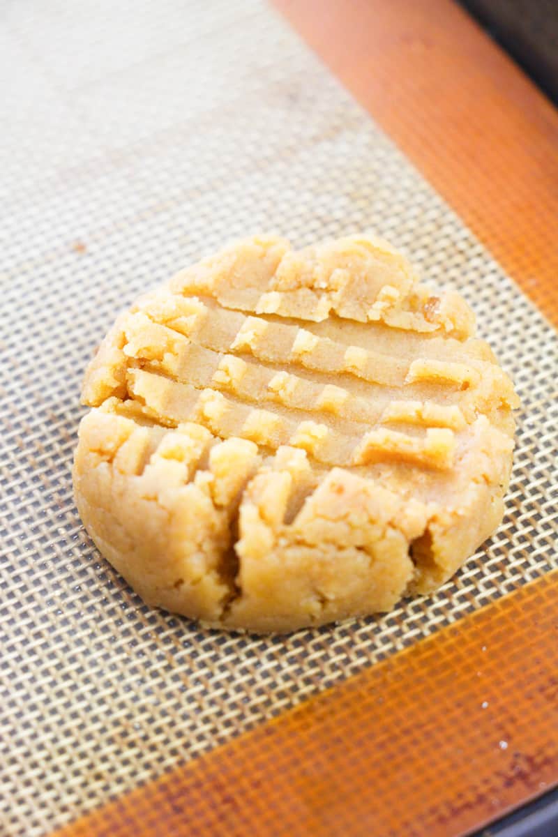 one easy vegan peanut butter cookie on a baking tray