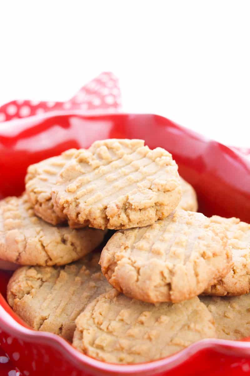easy vegan peanut butter cookies stacked on a red plate