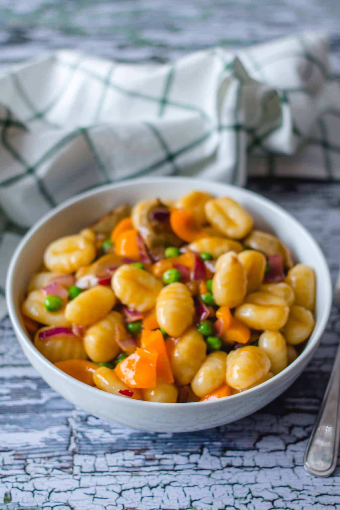 Gnocchi with vegan sausage and gravy served in a bowl