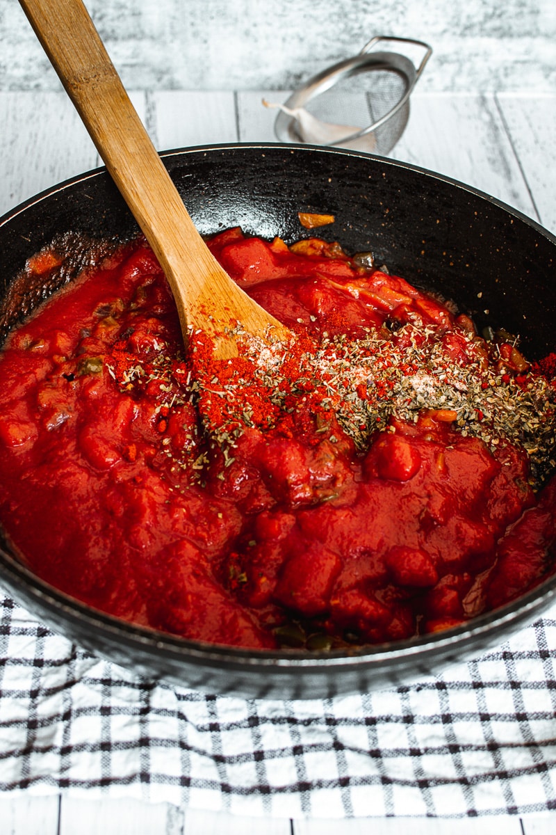 skillet of Vegan Bolognese Sauce with spices added