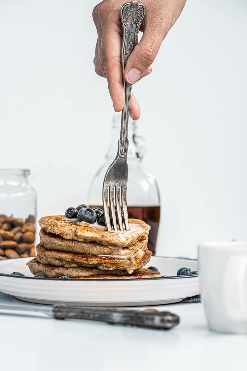 fork digging into vegan almond flour pancakes
