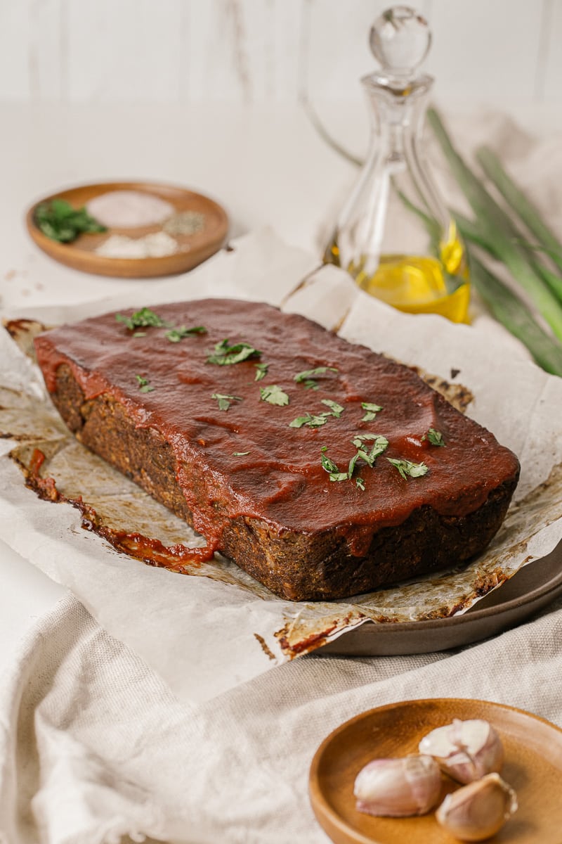 loaf of vegan lentil meatloaf with tomato sauce