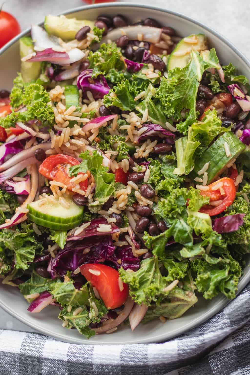 kale salad being served with a checkered cloth