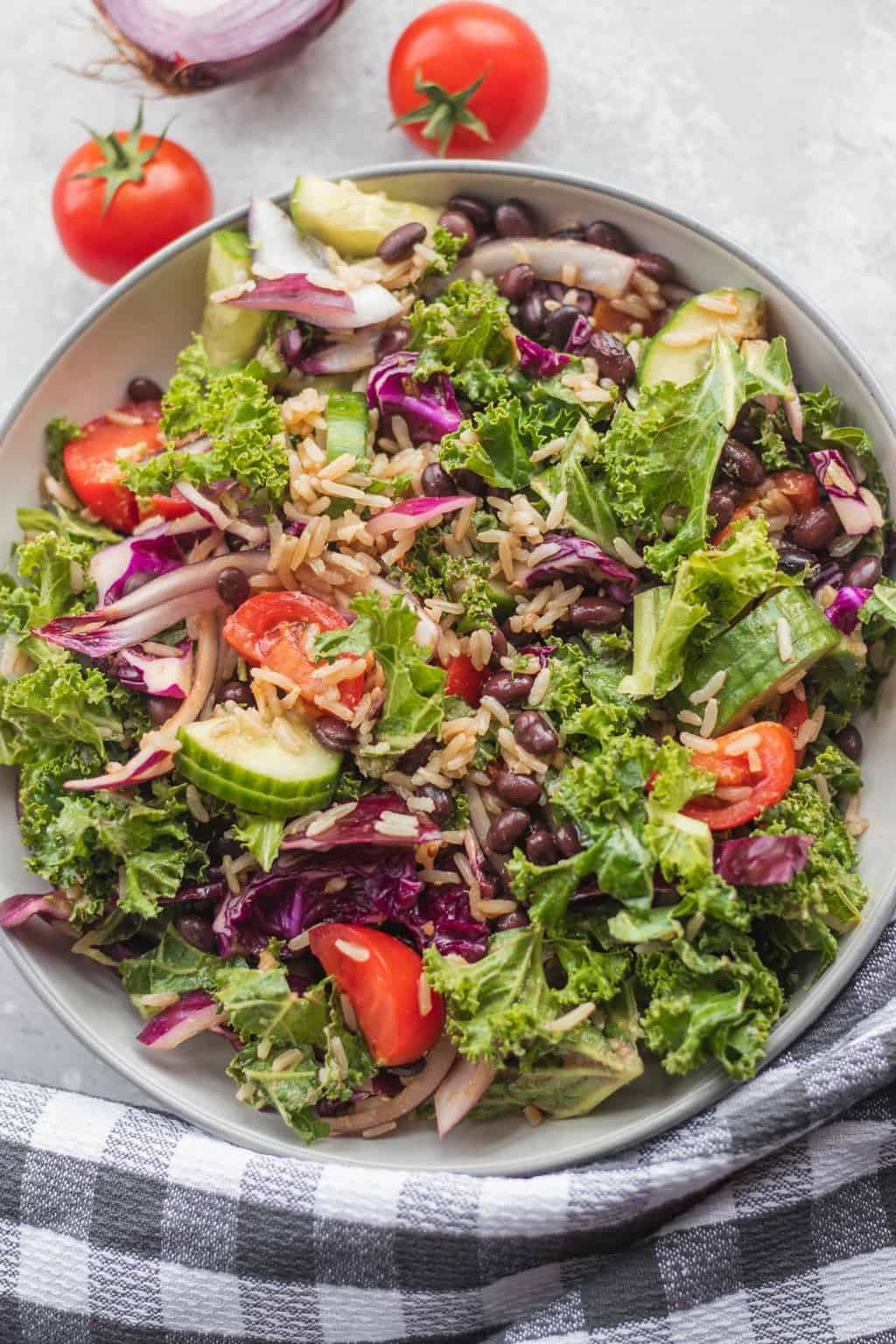 massaged kale salad being served in a white bowl