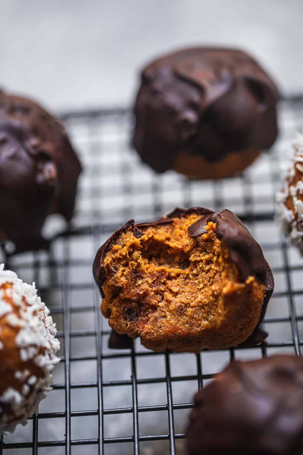 vegan carrot cake bliss balls with a bite out of one