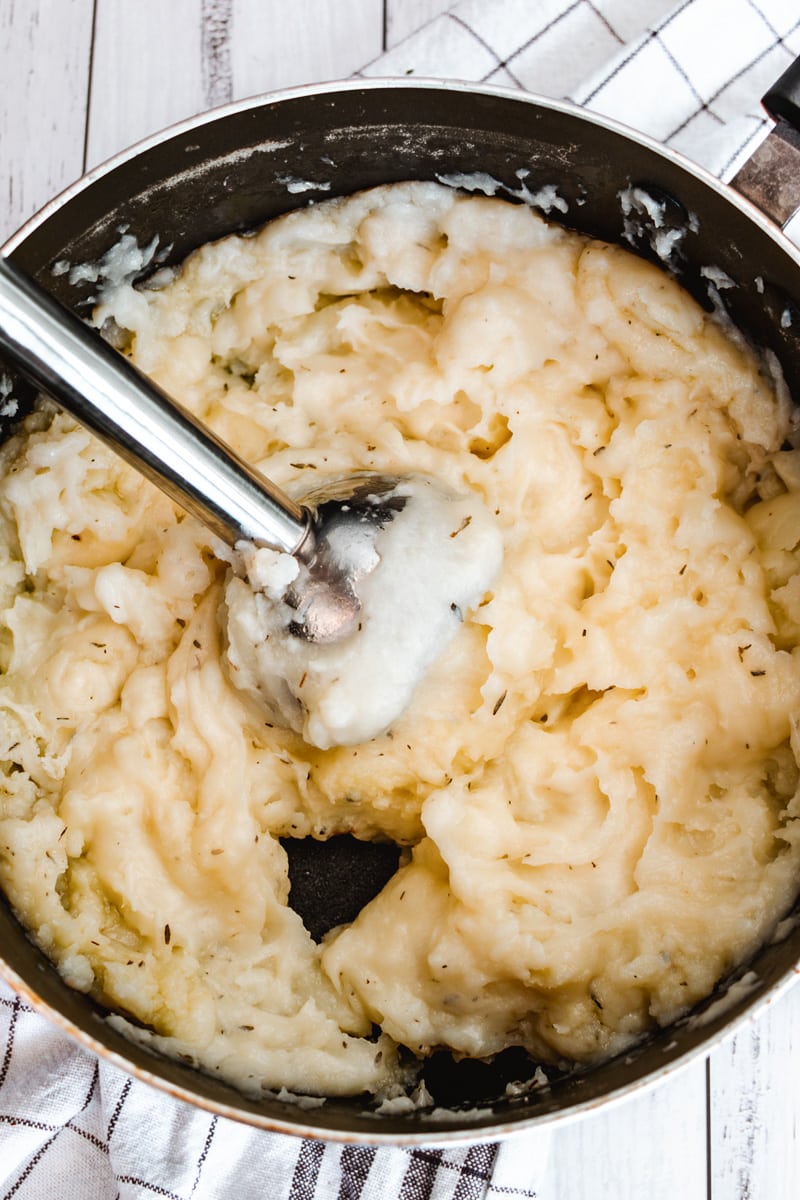 immersion blender in pot of vegan mashed potatoes tall