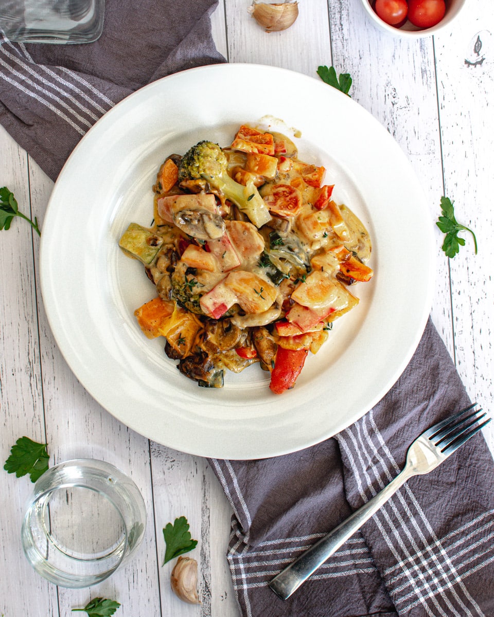 roasted veggies with vegan cheese sauce on a plate