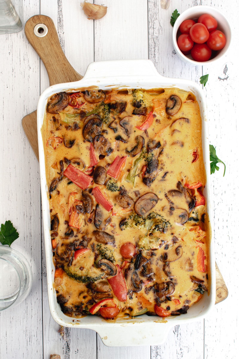 pan of roasted veggies with vegan cheese sauce