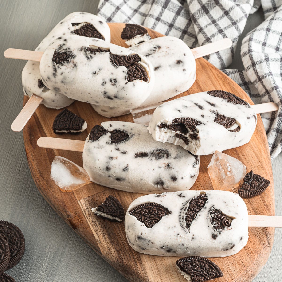 cookies & cream vegan popsicles stacked on wooden serving tray