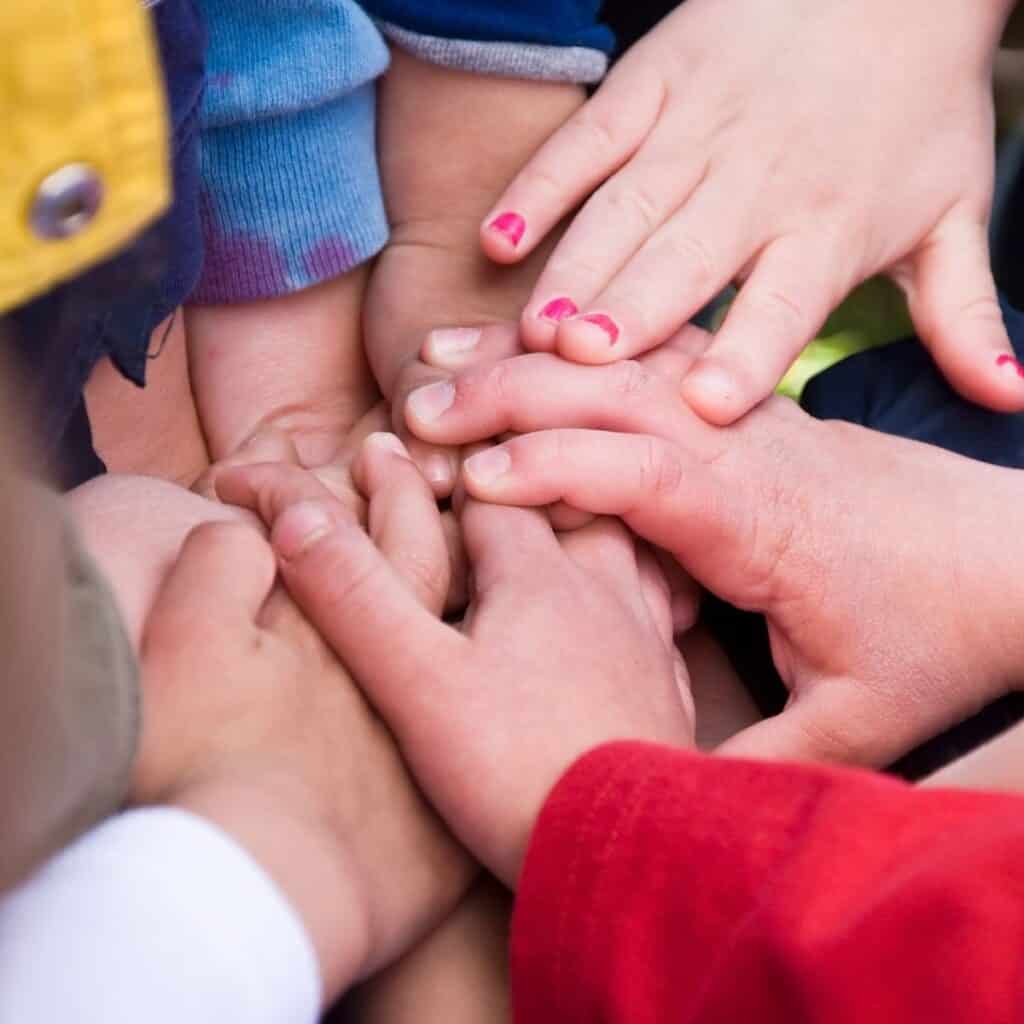 kids hands together as a team