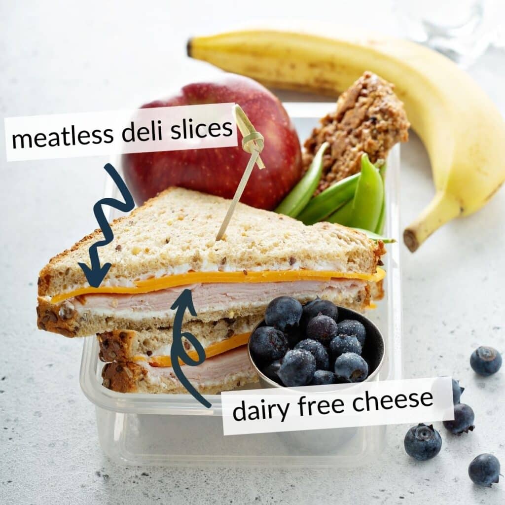 lunchbox with a sandwich made from vegan deli slices and dairy free cheese