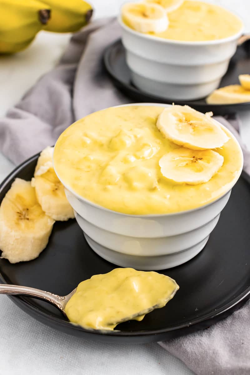 two bowls of vegan banana pudding with banana slices on top