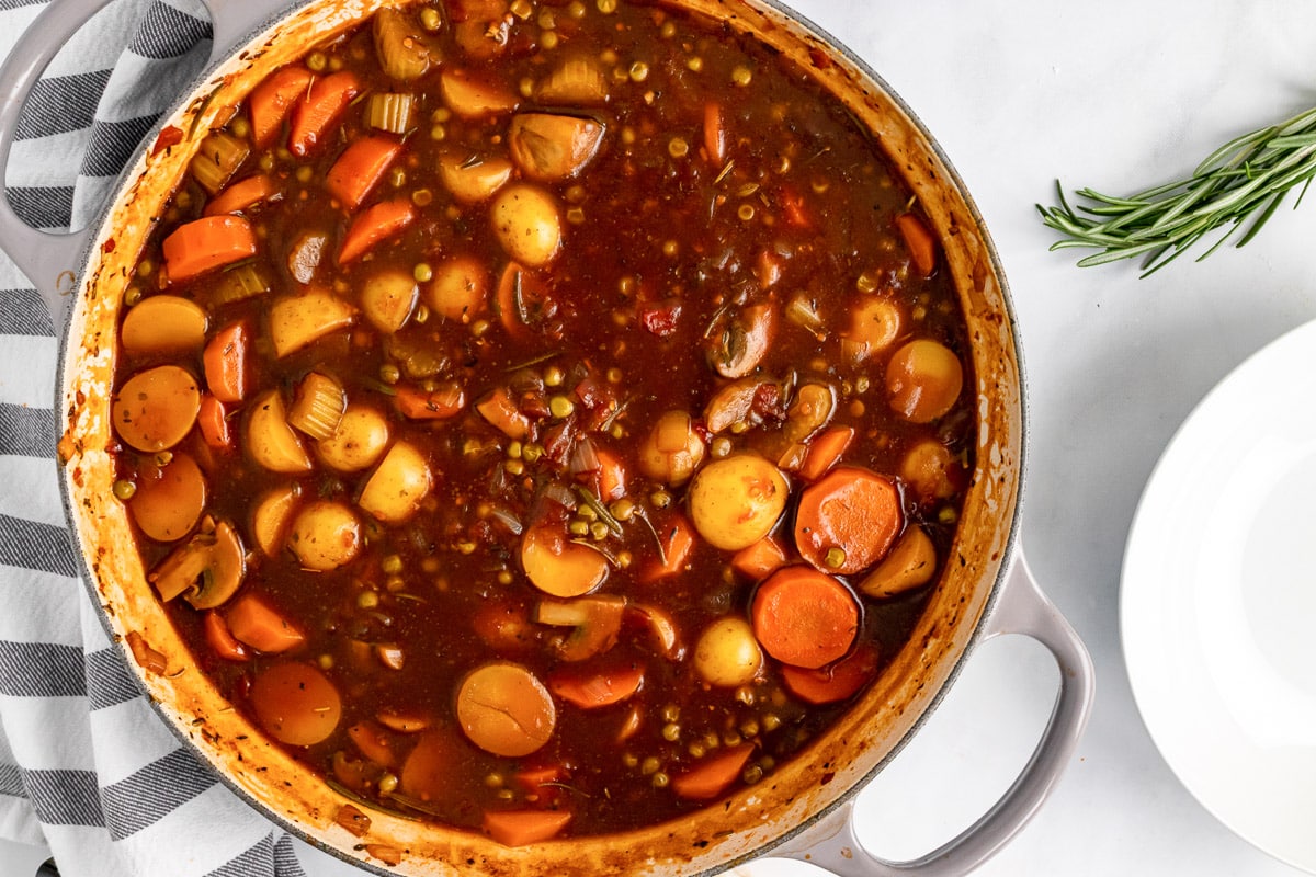 overhead view of a pot of old-fashioned vegan stew with fresh rosemary