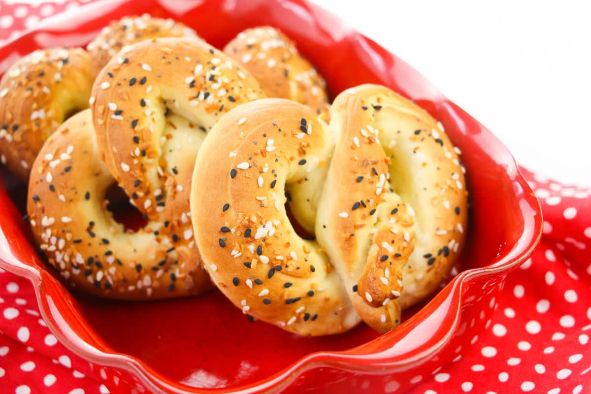 side view of vegan soft pretzels in red bowl