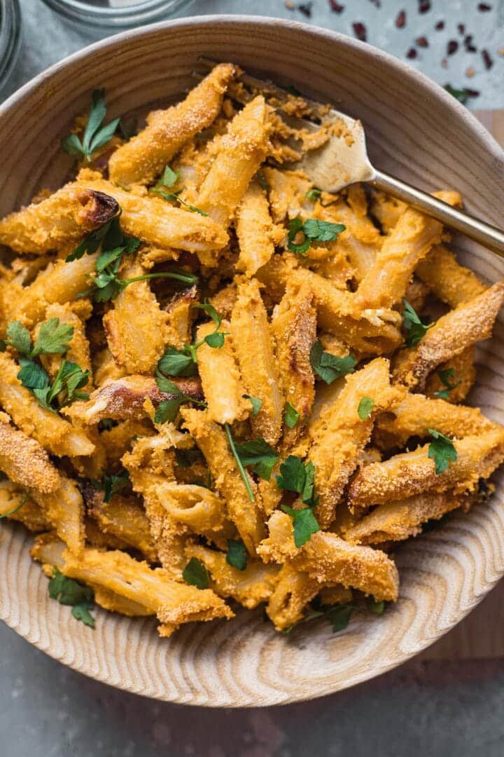 Bowl of vegan mac and cheese with fresh herbs