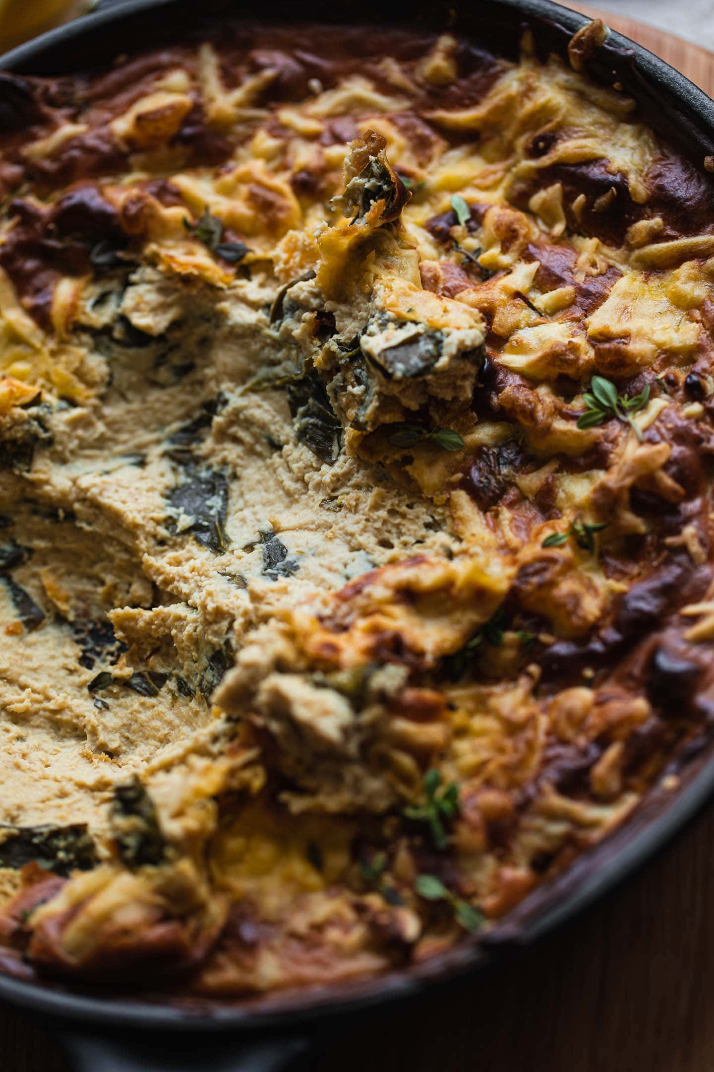 Closeup of a cheesy vegan dip with spinach
