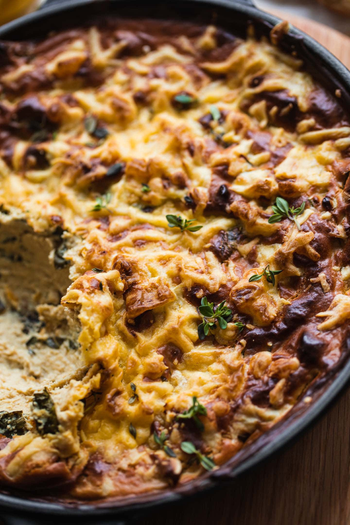 Closeup of a skillet with vegan spinach artichoke dip