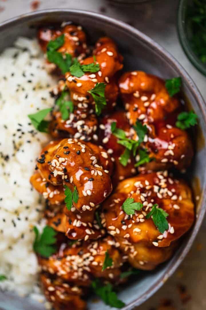 Closeup of cauliflower wings in a sweet and sour sauce with rice