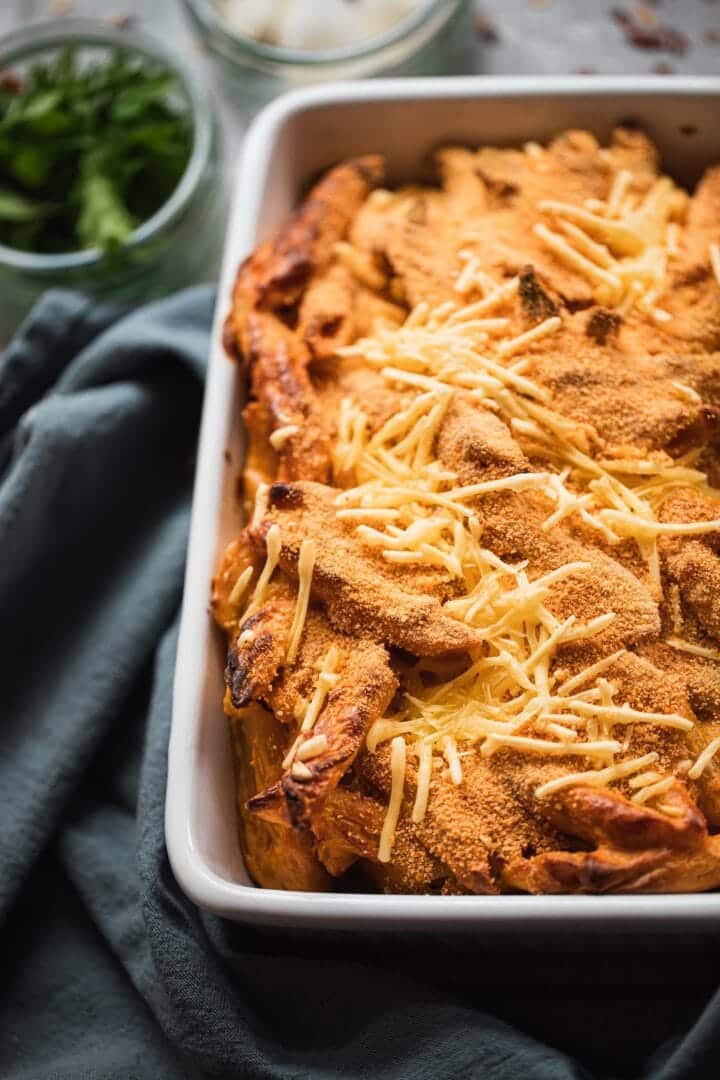 Dairy-free mac and cheese with breadcrumbs in a baking dish