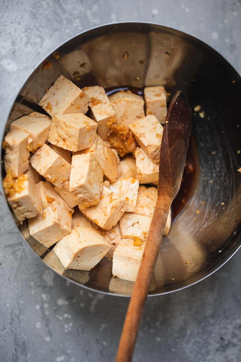 tofu marinating in a mixing bowl