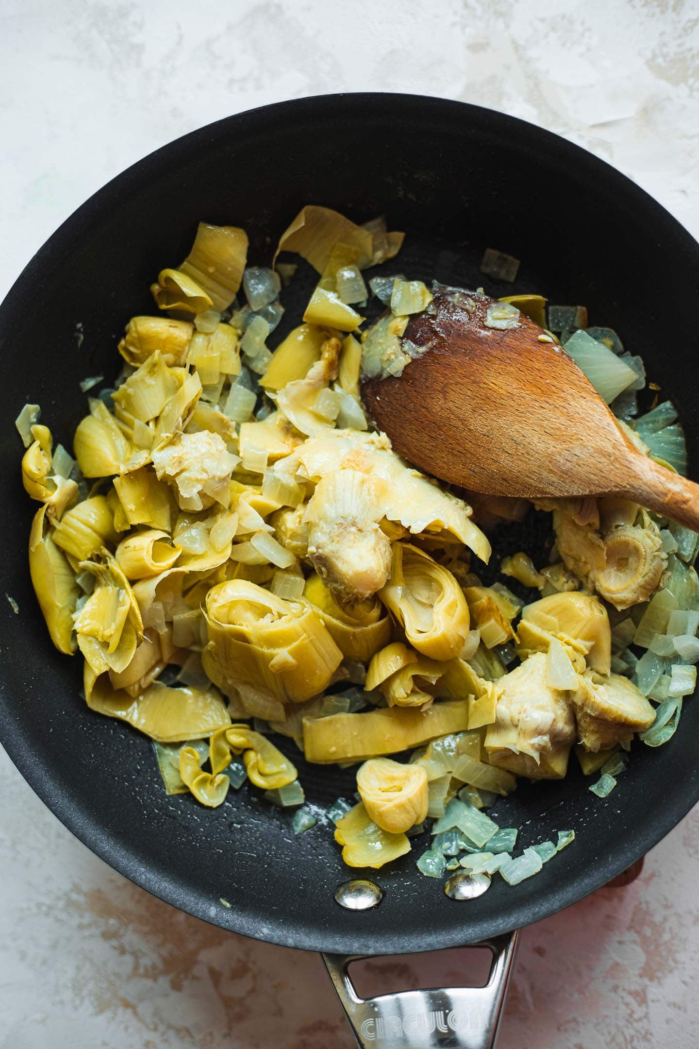 Onions and artichokes in a skillet