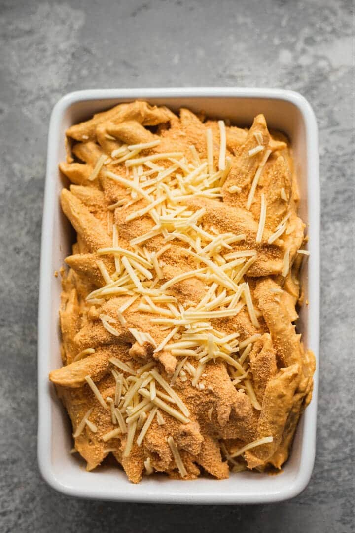 Vegan cheesy pasta with breadcrumbs in a baking dish