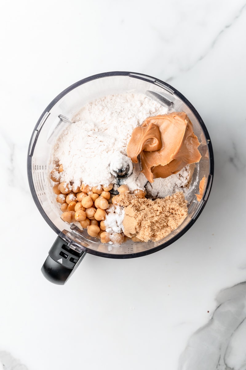 Chickpeas, flour, peanut butter and brown sugar in a food processor bowl before blending