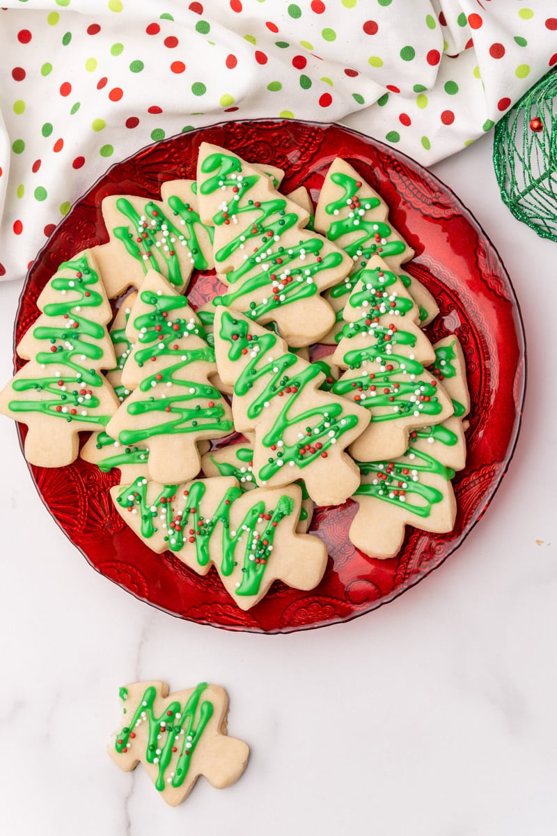 plate of vegan christmas cookies decorated to look like christmas trees
