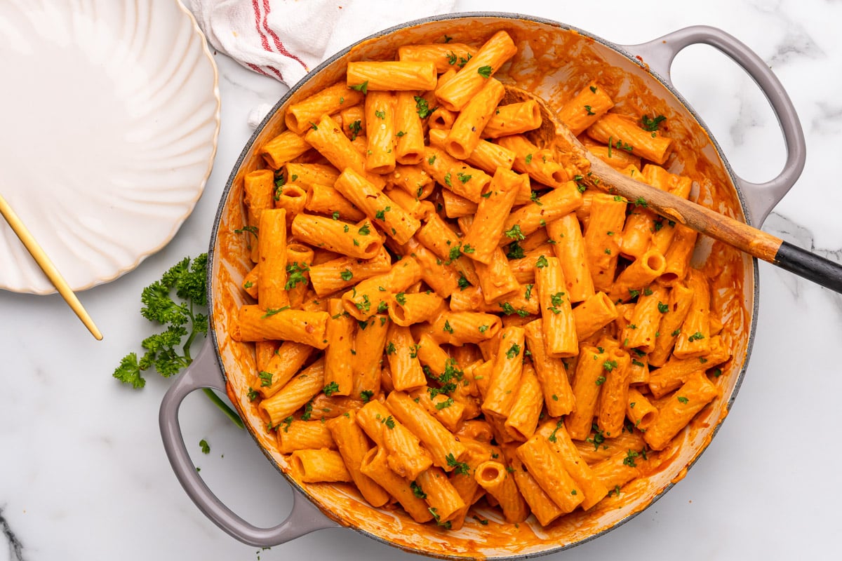 vegan vodka pasta being served from the pan